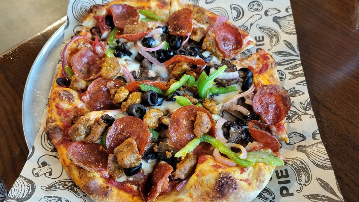 Lineage Supreme Pizza from Your Pie Pizza in Lumberton, North Carolina — topped with pepperoni, sausage, olives, peppers, onions, and mushrooms.