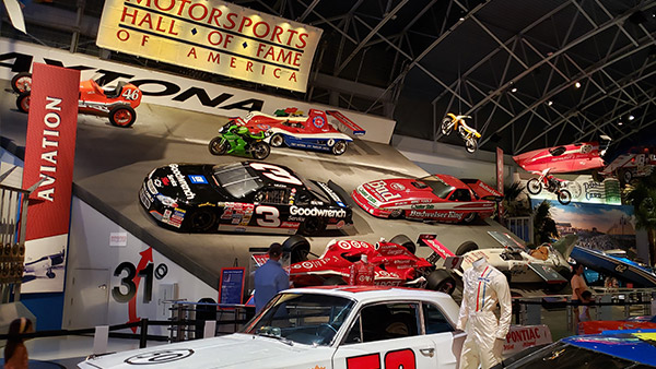 Interior exhibits at the Motorsports Hall of Fame of America in Daytona Beach, featuring historic race cars and motorsports displays