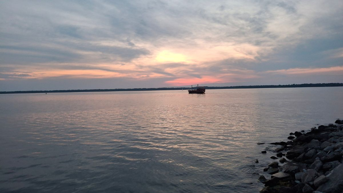Sunset over Lake Erie viewed from the Courtyard Erie Bayfront with calm water and pastel skies