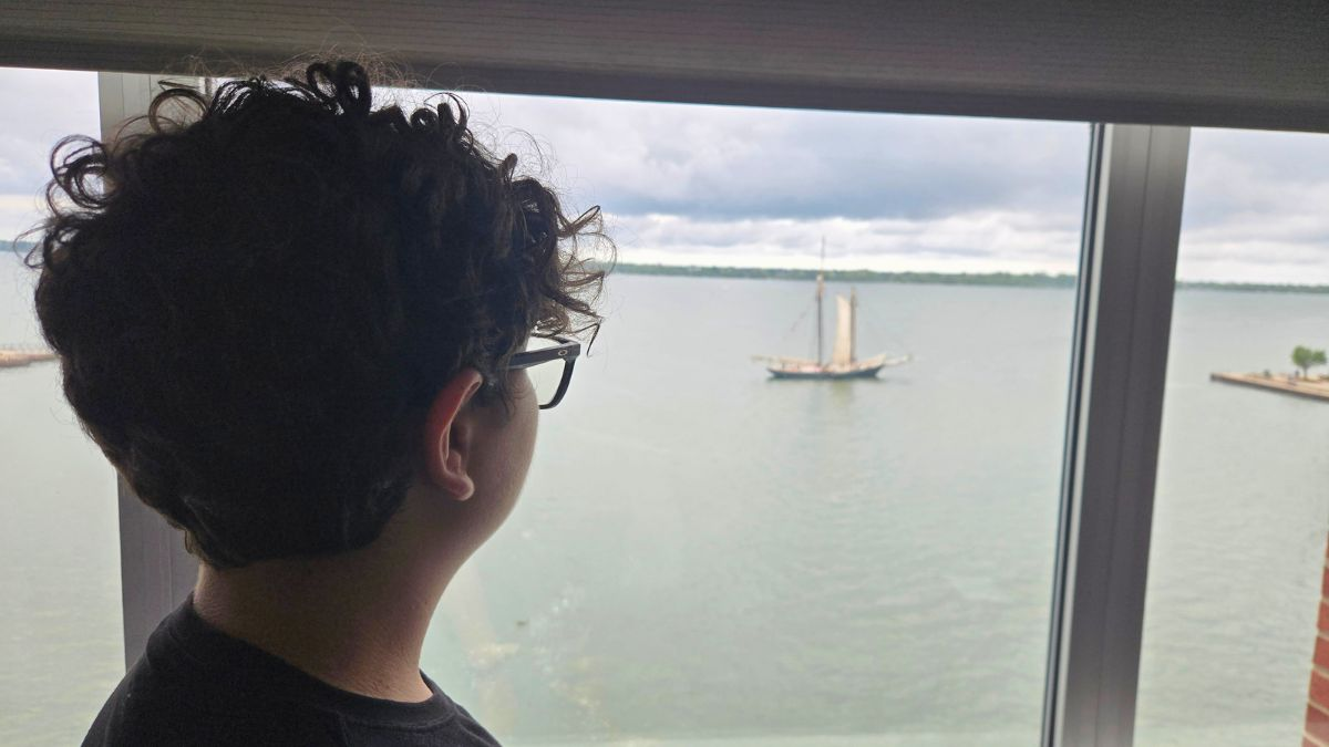 Teen hotel reviewer Mateo looking out from a hotel room during a real stay