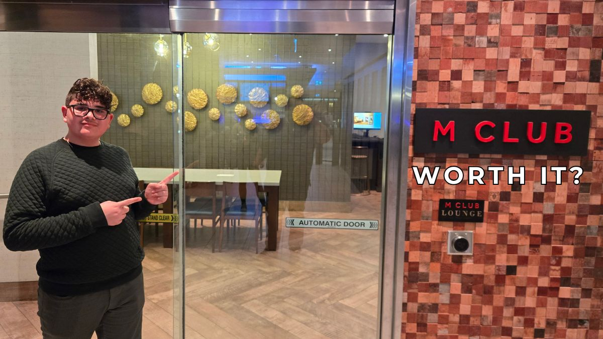 Teen reviewer pointing at Marriott M Club lounge entrance asking if hotel lounge access is worth it
