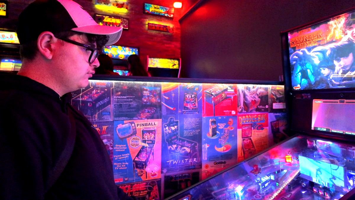 Mateo playing pinball at Tilt Arcade Bar near Residence Inn London Downtown