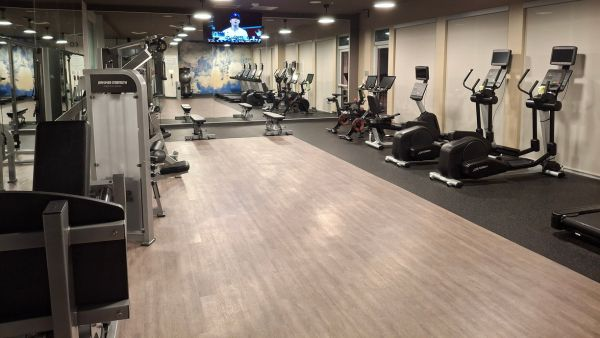Fitness centre at Courtyard Titusville Kennedy Space Center with cardio machines weights and Space Shuttle mural